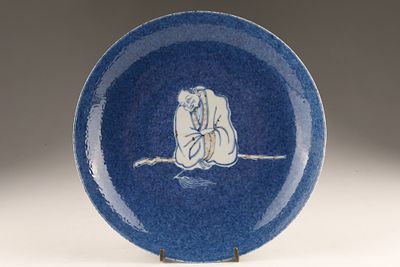 Chinese Powder Blue Ground Blue and White Budai Dish featuring a central figure of Budai (the 