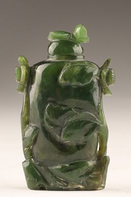 Antique Chinese Spinach Green Jade Snuff Bottle decorated with high relief carved foliage and 
