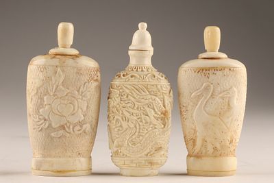 A Group of Three Chinese Carved Snuff Bottles decorated with dragons, herons and flowers. 