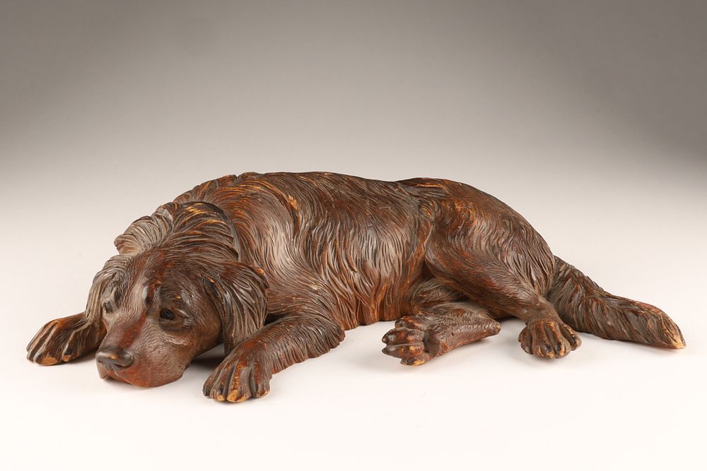 A 19th-century Bavarian or Swiss Black Forest Carved Recumbent Dog. A 19th-century Bavarian or 