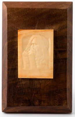 Moses – A Relief. Moses, relief (not signed), placed on a wooden base. Profile of Moses looking 
