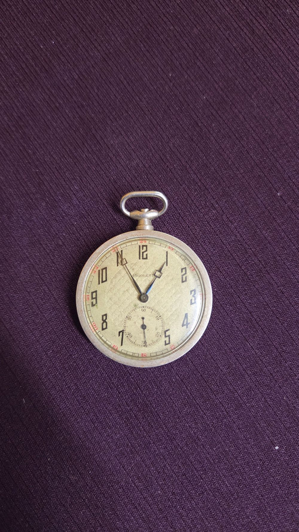 Lot 605 – Huguenin Silver Toned Pocket Watch with Textured Dial Swiss made movement marked with case number 28867.