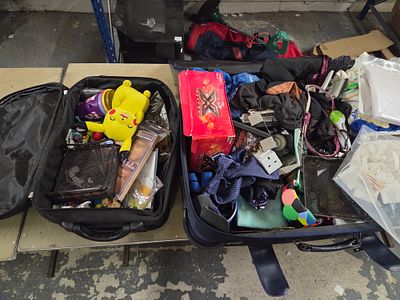 A Collection of Miscellaneous Items within Two Black Suitcases