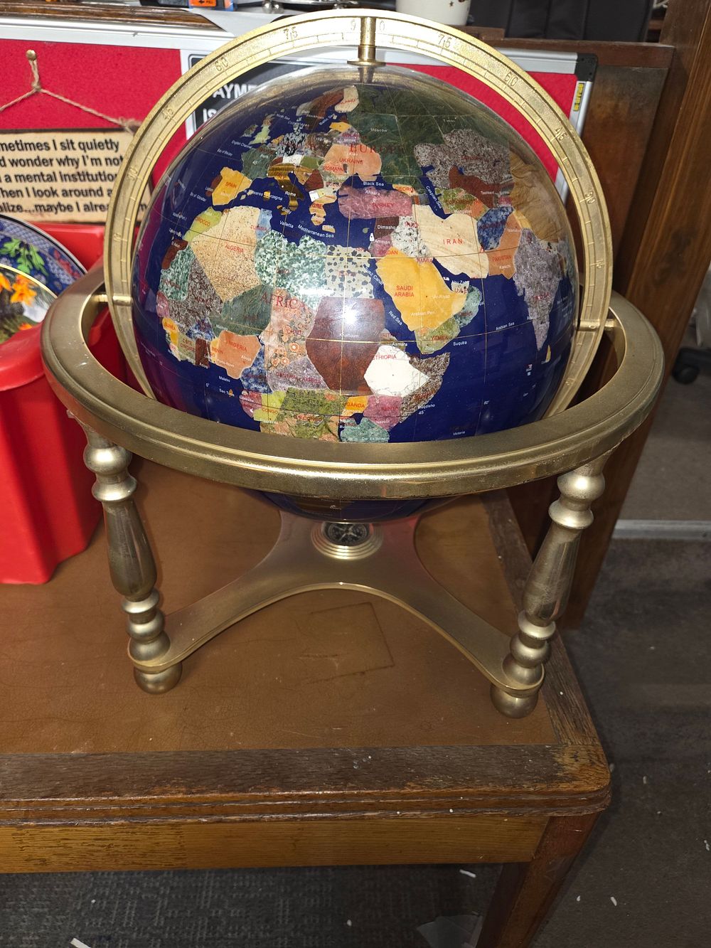 Lot 363 – Gemstone World Globe with Navy Blue Oceans on Metal Stand
