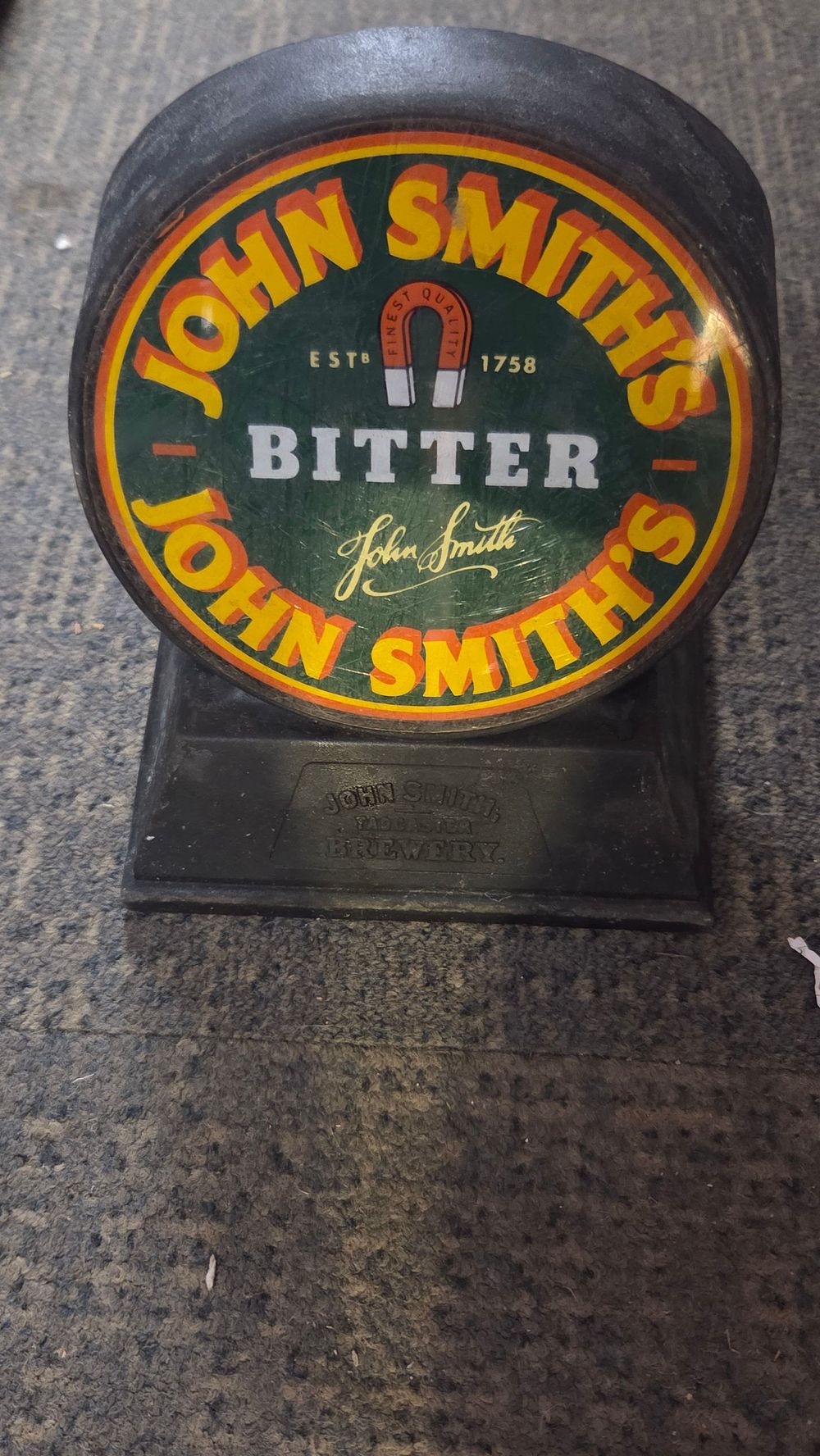 Lot 186 – John Smith’s Bitter Beer Pump Badge and Base