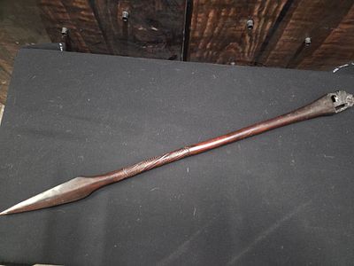 Carved Wooden Zulu Style Stabbing Spear. A dark brown carved wooden spear featuring a pointed 