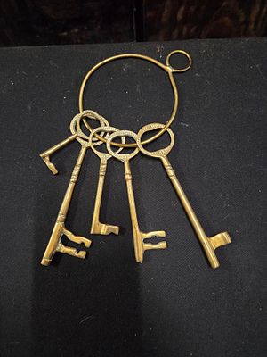 A Collection of Decorative Brass Skeleton Keys on Ring. A collection of brass-coloured skeleton 