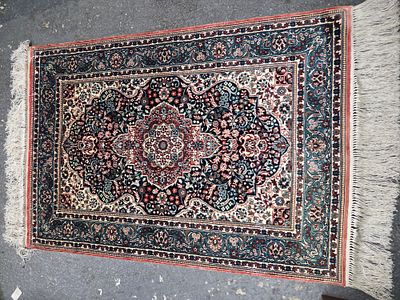 Multi-coloured silk carpet with intricate floral patterns. A multi-coloured silk carpet 