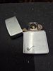 Zippo Silver-Toned Pipe Lighter with Etched Pipe Graphic. A silver-toned Zippo pipe lighter Image - 2