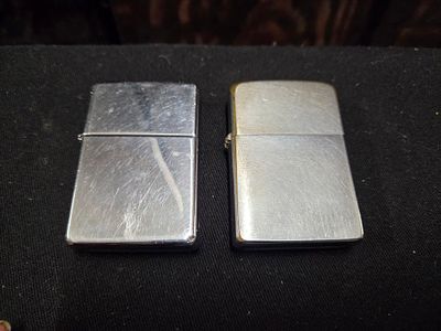 A Pair of Zippo Brushed and Polished Chrome Lighters. A pair of silver-toned metal pocket 