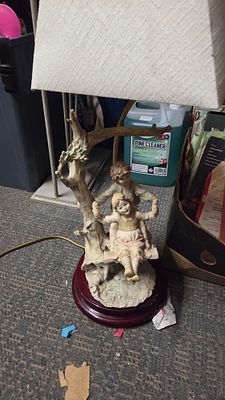 Porcelain figurine of two children on a tree swing lamp