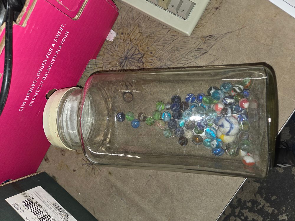 Lot 553 – A Collection of Multi-coloured Glass Marbles in a Jar