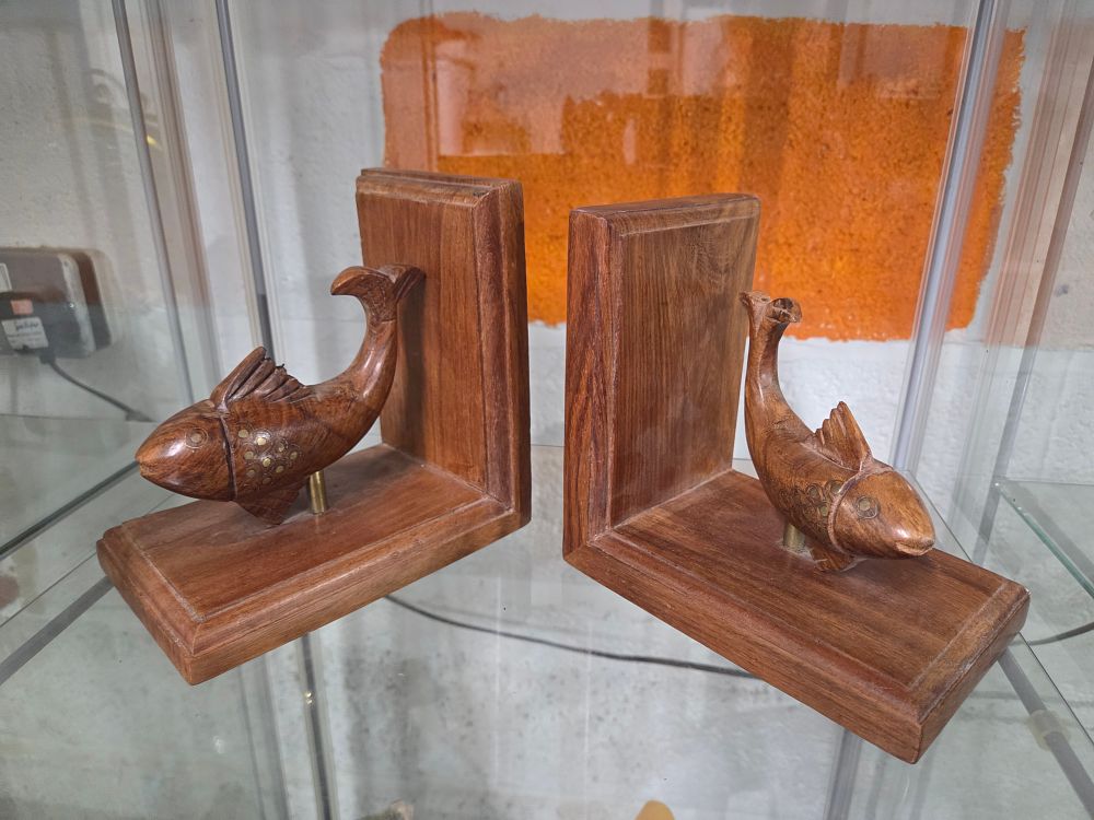 Lot 607 – A Pair of Carved Wooden Fish Bookends with Brass Inlays