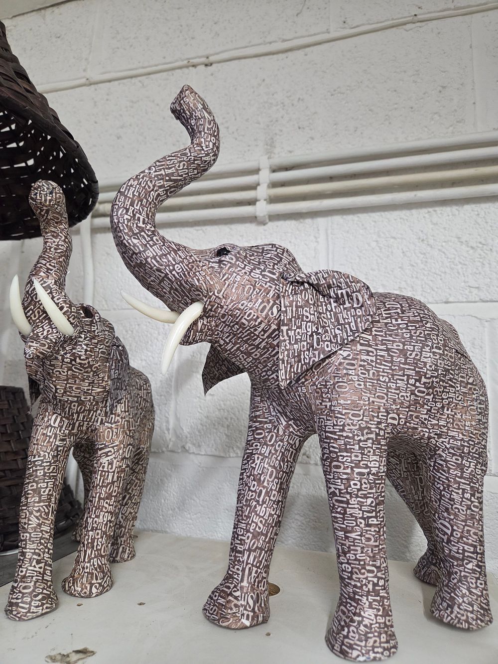 Lot 622 – A Pair of Brown Typography Pattern Elephant Figurines