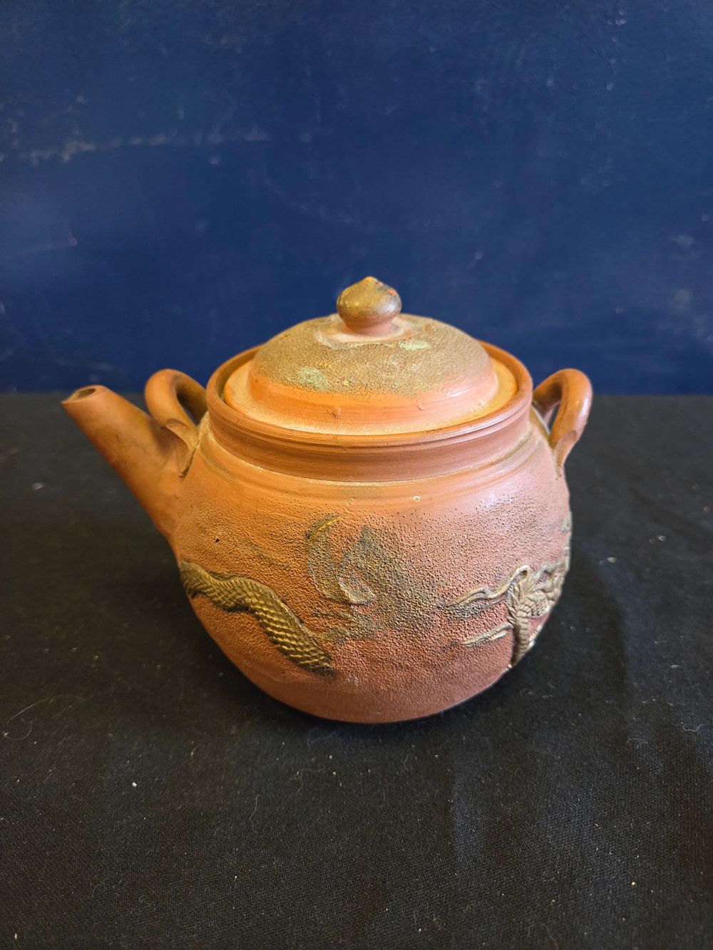 Lot 163 – A Chinese Yixing-style red stoneware dragon teapot and cover, late 19th or early 20th century