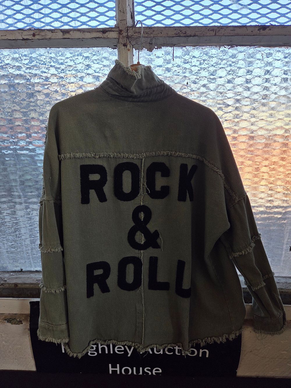 Lot 349 – An Elan Devan olive green cotton utility jacket with Rock & Roll motif