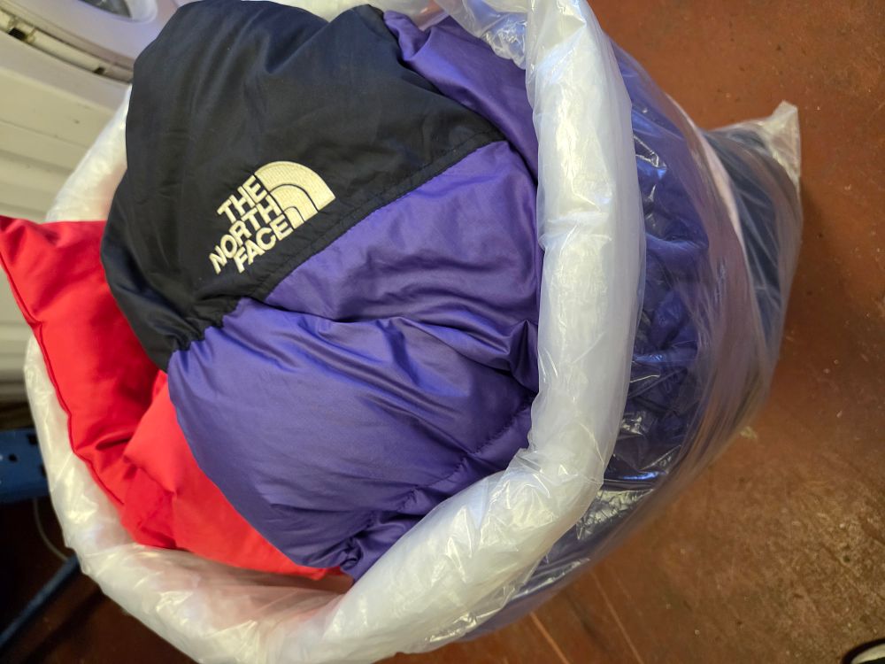 Lot 384 – A Bag of Coats inc The North Face Nuptse Purple and Black Puffer Jacket