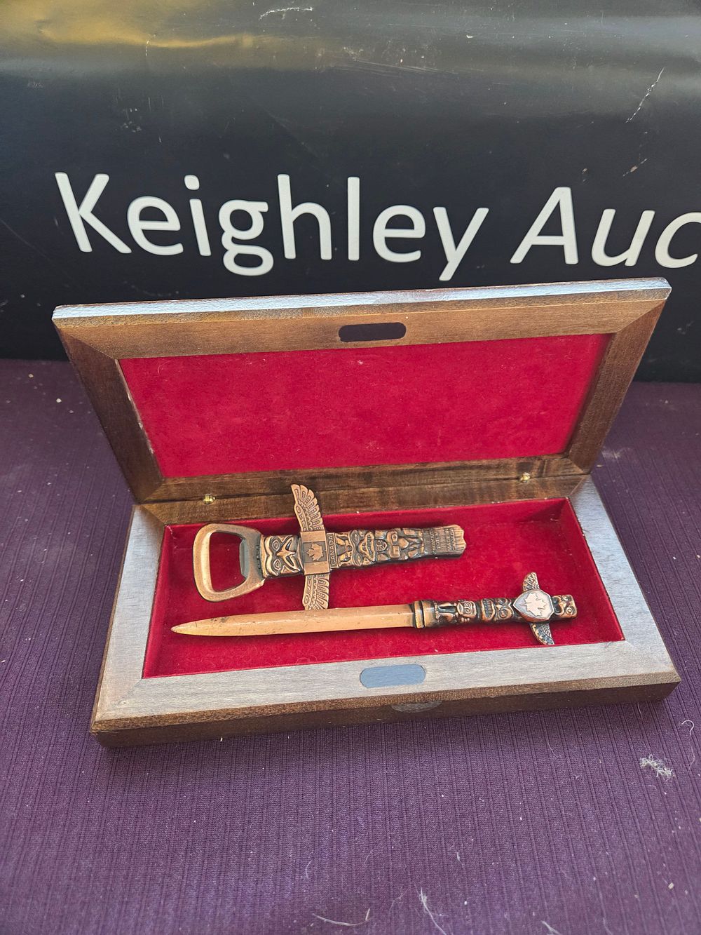 Lot 634 – A Pair of Wakuti Totem Bronze-Toned Bottle and Letter Openers in a Presentation Case