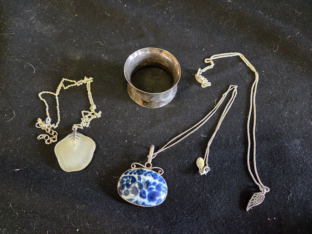 Lot 191 – A Collection of Four Silver Items including Three Pendant Necklaces and a Napkin Ring 45.54 grams