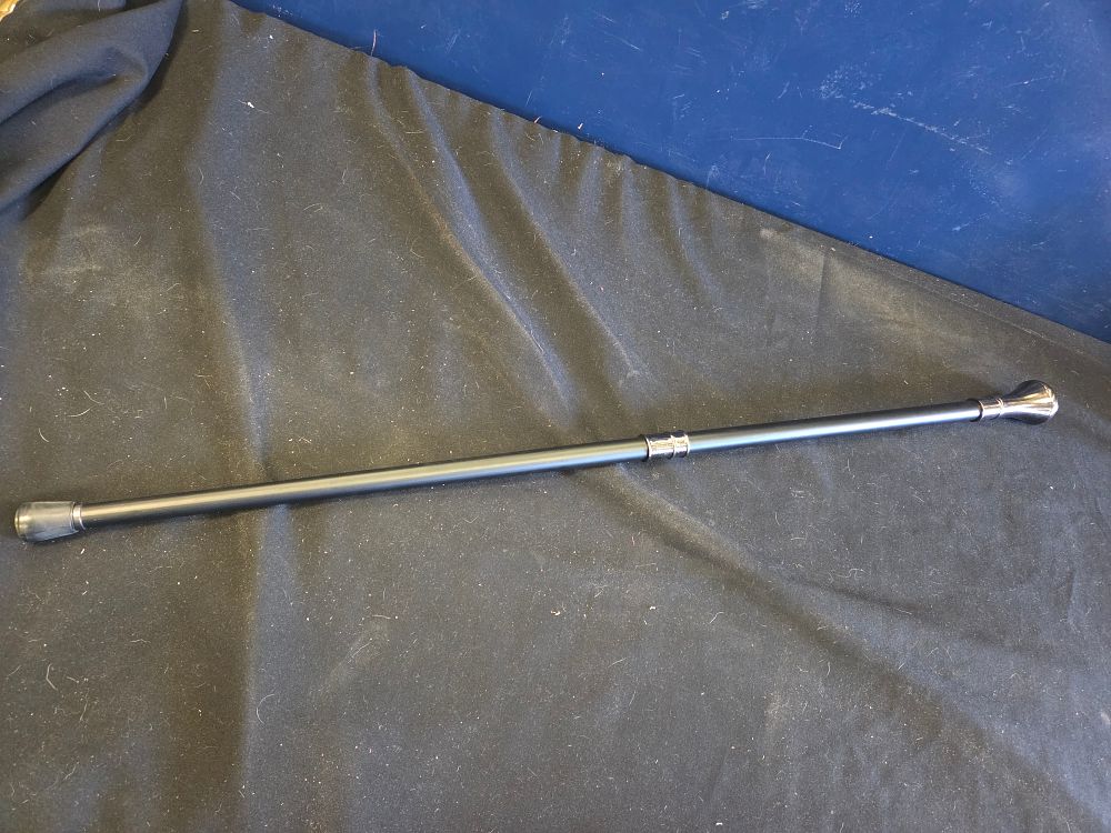 Lot 235 – A contemporary walking cane with embossed silver-toned knob handle