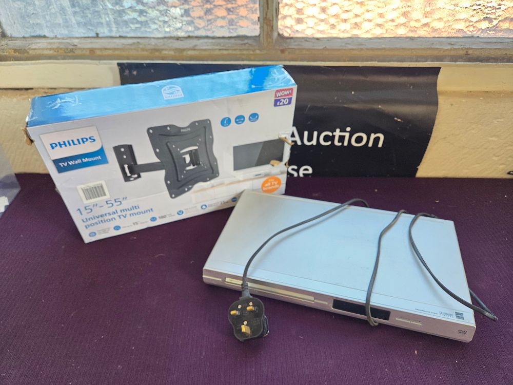 Lot 247 – Two home media items comprising a Philips universal TV wall mount and a silver-toned DVD player in working order