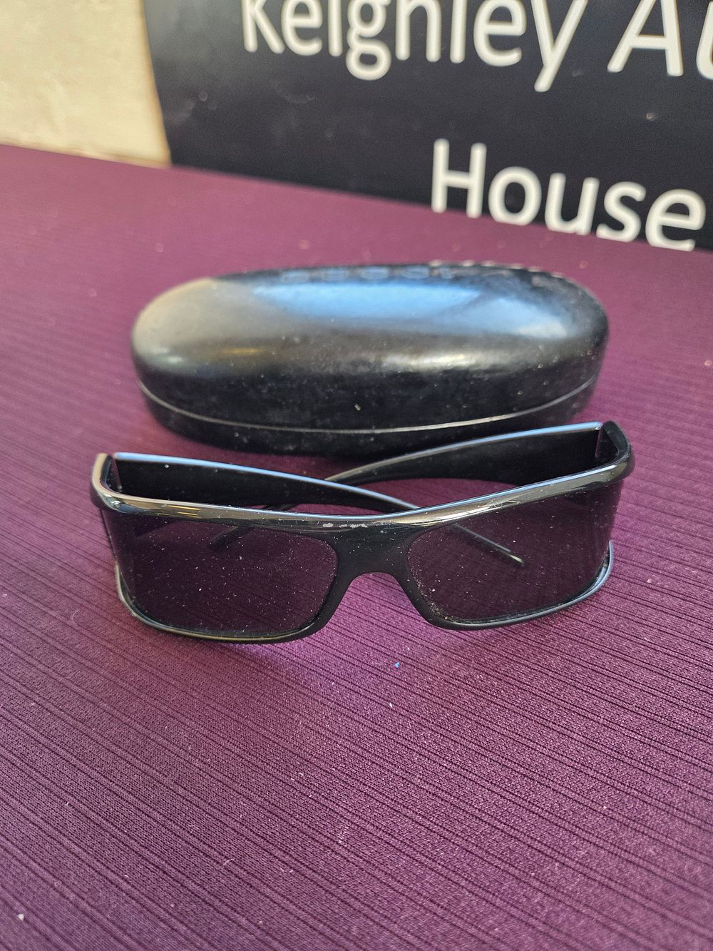 Lot 607 – A pair of Gucci black wrap-around sunglasses and case