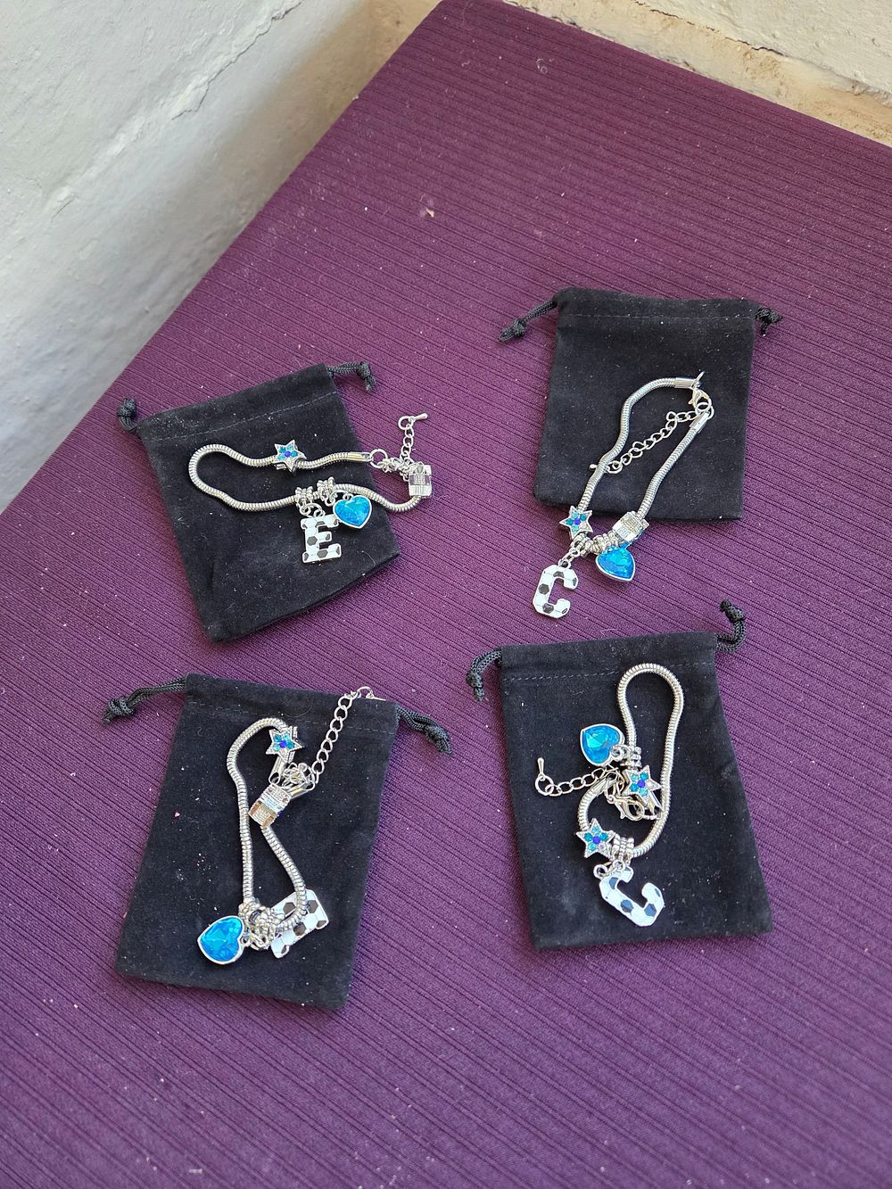 Lot 635 – A Set of Silver-Tone Snake Chain Charm Bracelets