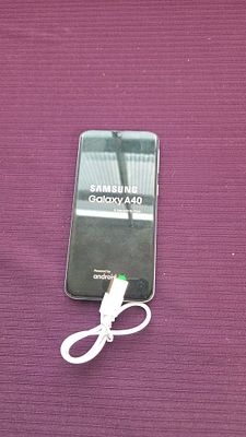 Samsung Galaxy A40 Smartphone with Charging Cable powers on