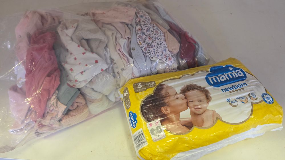 Lot 235 – An Assortment of Infant Clothing and a Pack of Mamia Newborn Size 3 Nappies