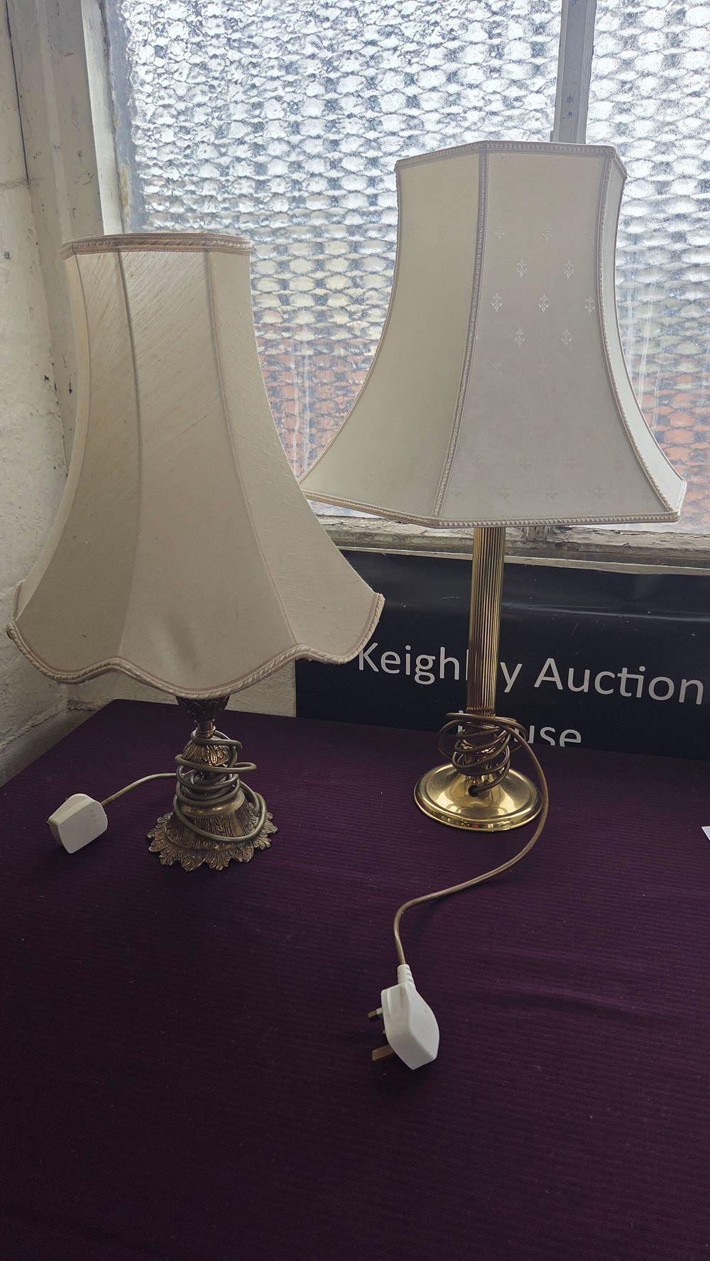 Lot 324 – Two brass and cast metal table lamps with fabric shades