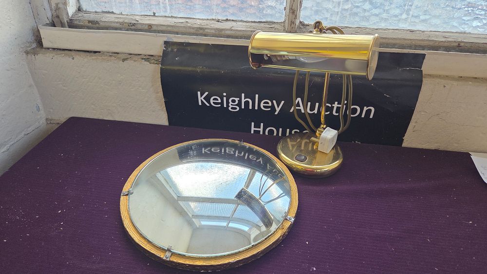 Lot 341 – Two items comprising a brass-finished adjustable desk lamp and a circular convex wall mirror