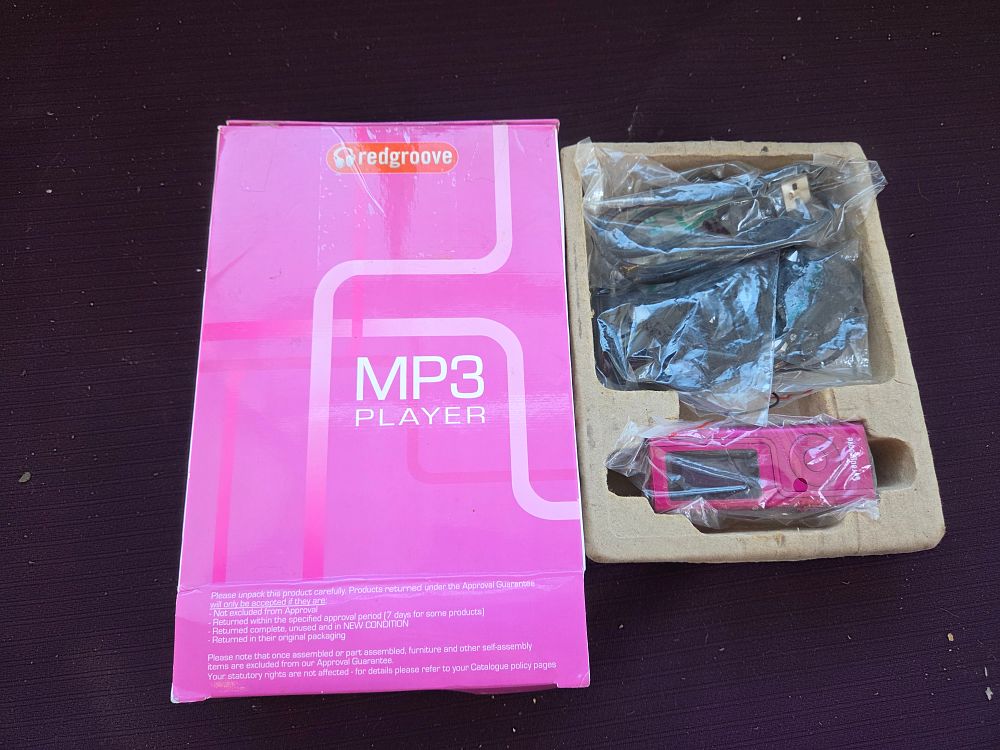 Lot 414 – A Redgroove MP3 Player in Pink with Accessories and Original Packaging in working order
