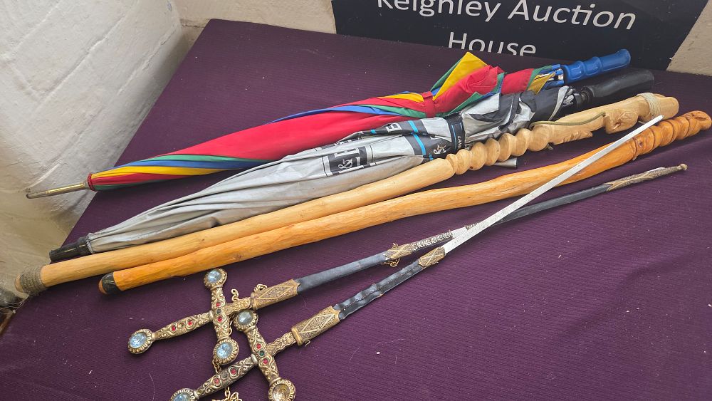 Lot 155 – A Collection of Carved Wood Walking Sticks, Decorative Daggers, and Umbrellas