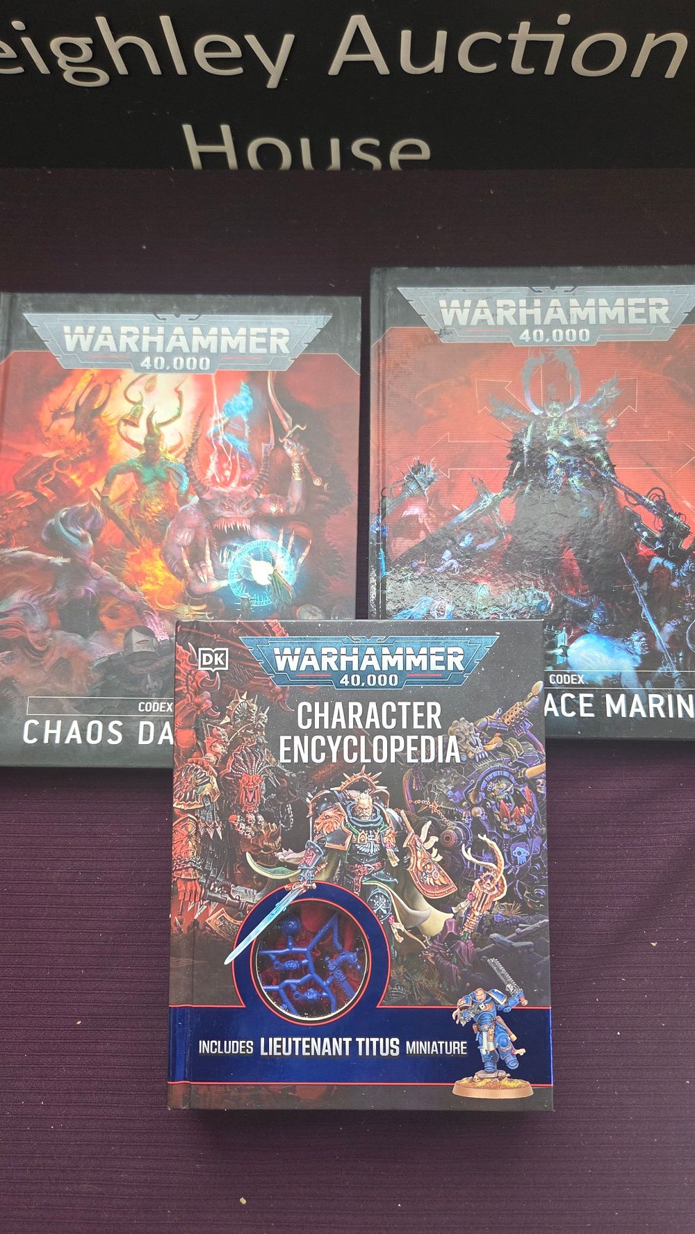 Lot 210 – Pryce, Wade. Three Volumes: Warhammer 40,000 Character Encyclopedia and Two Codex Supplements. DK and Games Workshop, 2024.