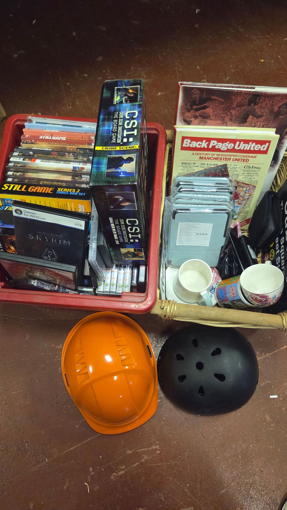 Lot 300 – Two Boxes of Collectables, Media, Games, and Headwear including CSI: The Board Game and Manchester United Memorabilia