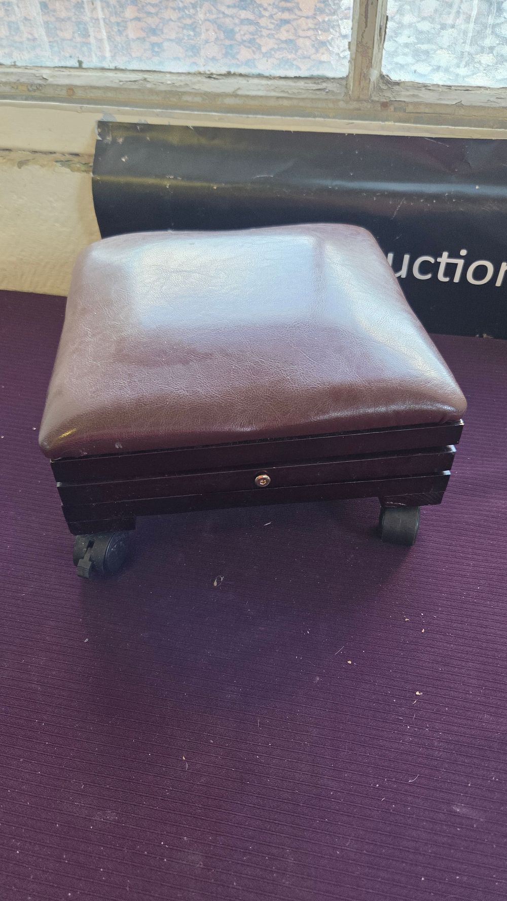 Lot 208 – A modern adjustable upholstered footstool on castors