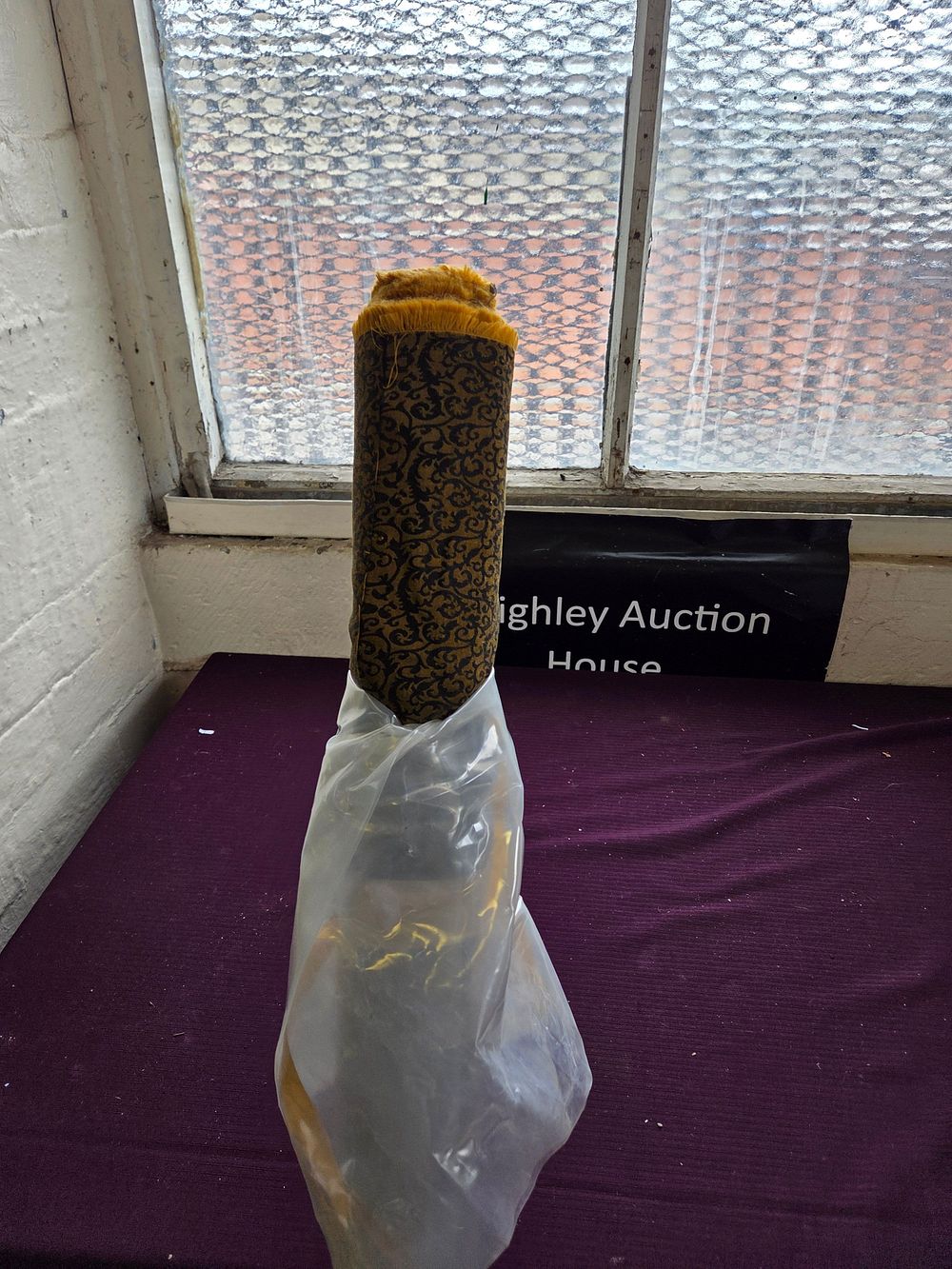 Lot 357 – A Roll of Patterned Ochre and Black Textile with Fringed Edge