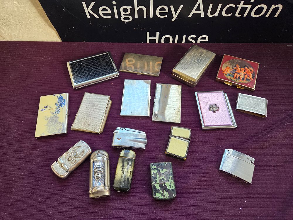 Lot 601 – An Assortment of Vintage Cigarette Cases, Pocket Lighters, and Personal Accessories