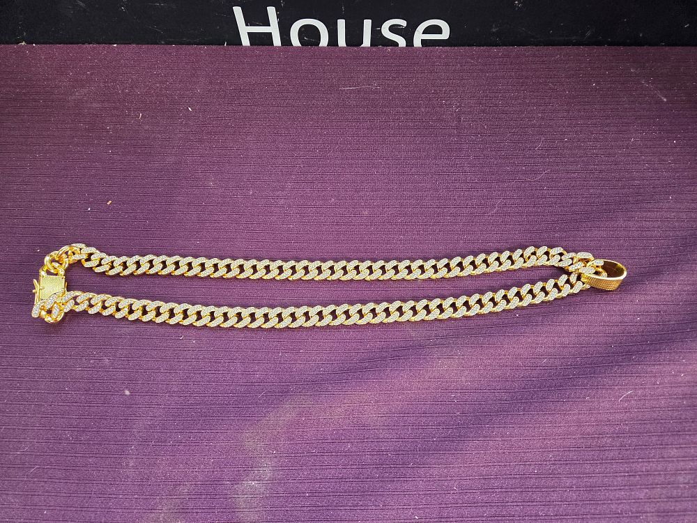 Lot 604 – A yellow metal stone-set Cuban link necklace
