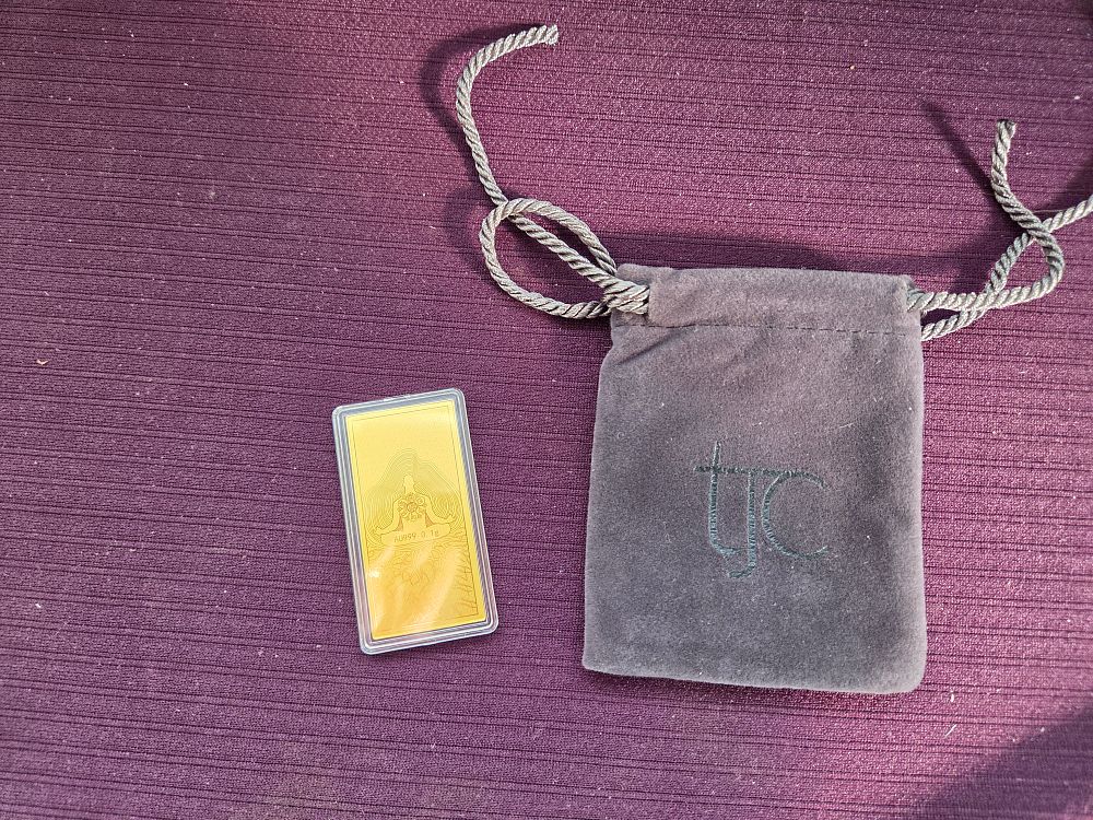 Lot 611 – A 24k Gold Bullion Bar with TJC Pouch