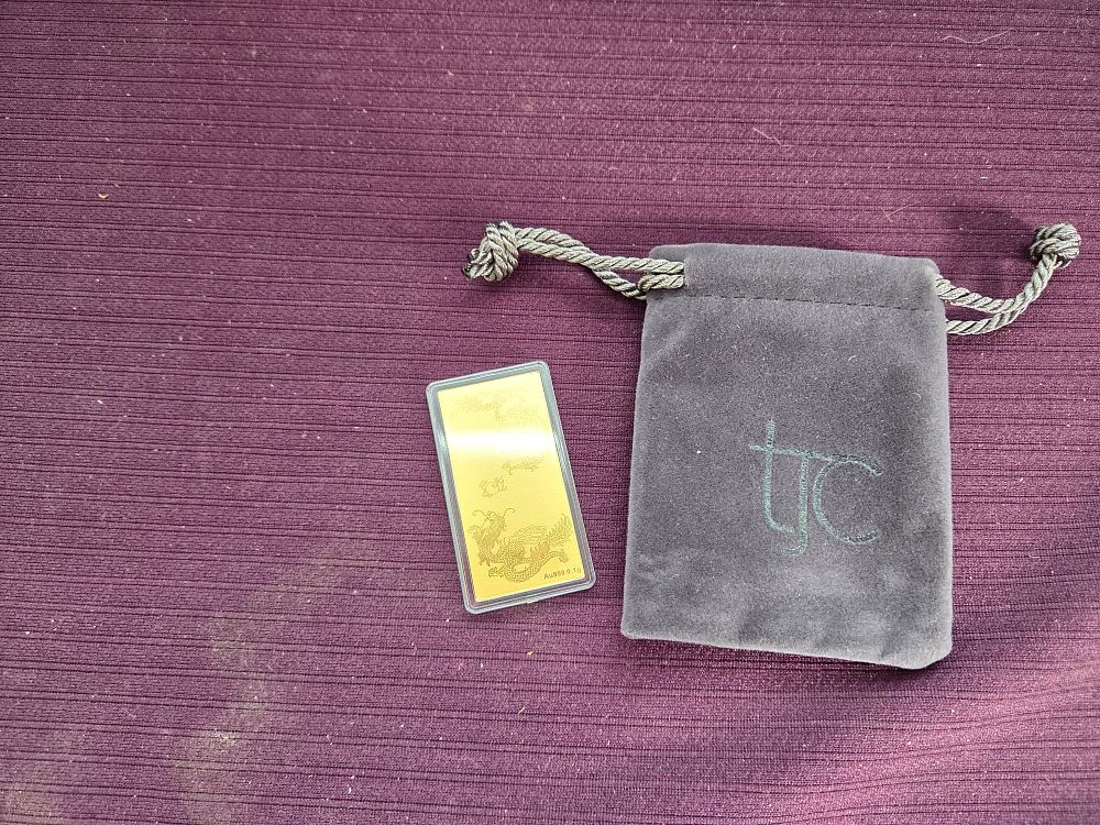 Lot 612 – A 24k Gold Dragon Bullion Bar
