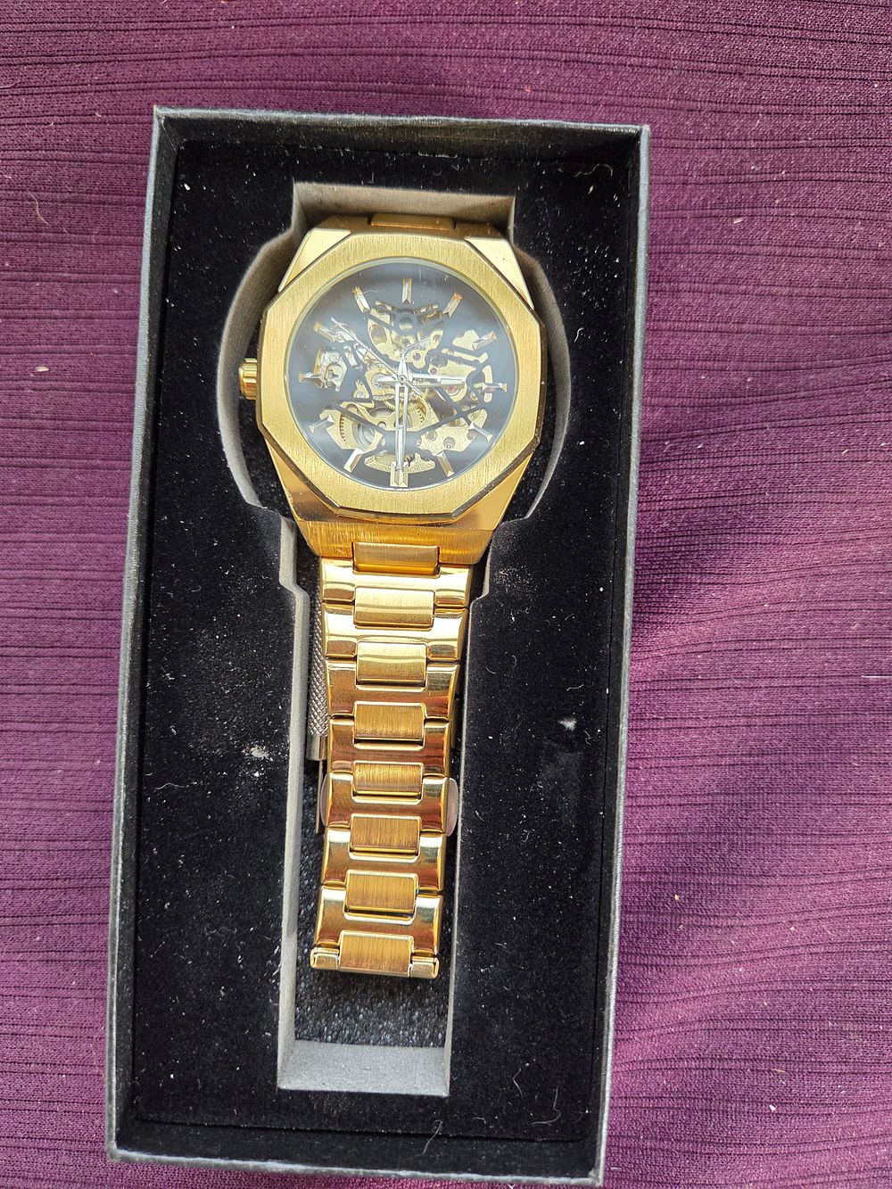 Lot 616 – A gold-tone skeletonised automatic mechanical wristwatch in the style of a luxury sports watch