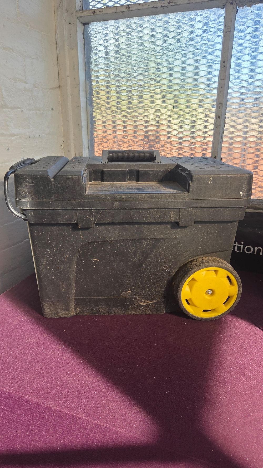 Lot 351 – A Large Mobile Plastic Tool Chest with Yellow Wheels