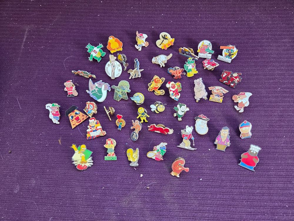Lot 621 – An Assortment of Vintage Pop Culture Corporate and Charity Enamel Lapel Pins