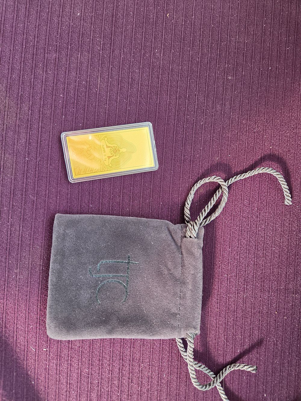 Lot 639 – A 24k Gold Bullion Bar with TJC Pouch
