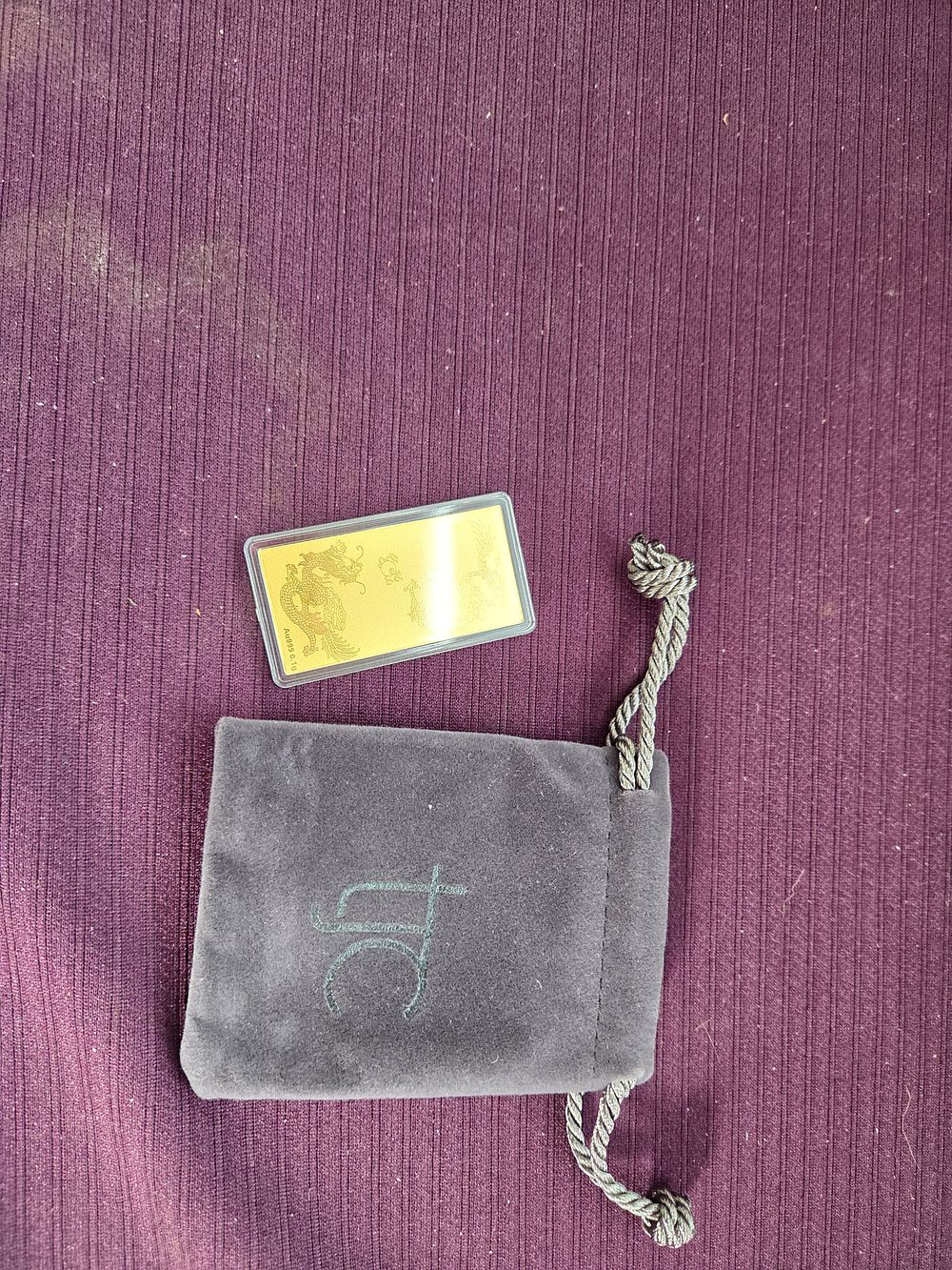Lot 640 – A 24k Gold Dragon Bullion Bar