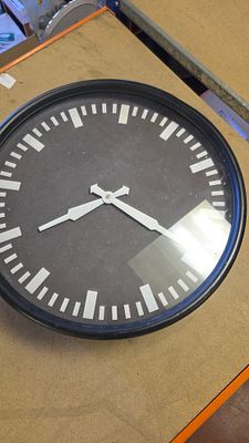 An Industrial Style Circular Wall Clock with Black Dial