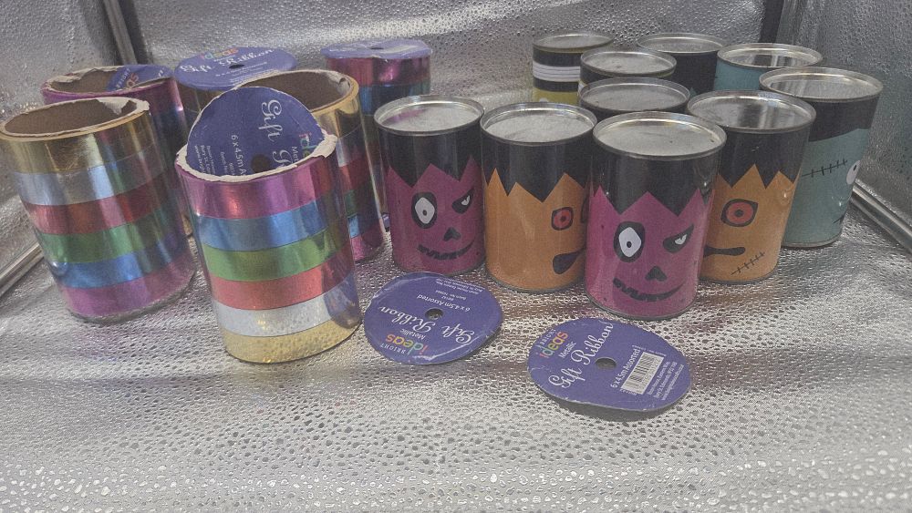 Lot 326 – An Assortment of Bright Ideas Metallic Ribbon and Halloween Monster Themed Tins