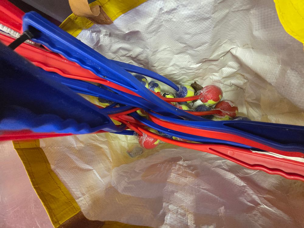 Lot 410 – An Assortment of New Plastic Pet Ball Throwers and Multi-Coloured Tennis-Style Balls