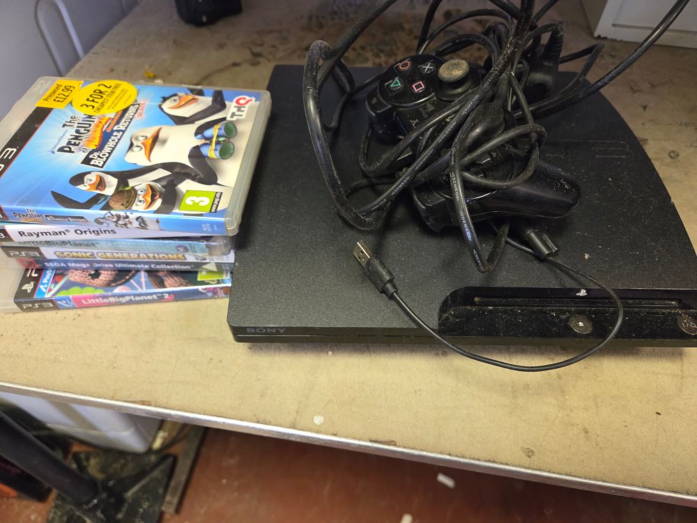 Lot 421 – A Sony PlayStation 3 Super Slim Video Game Console with Controller and an Assortment of Games